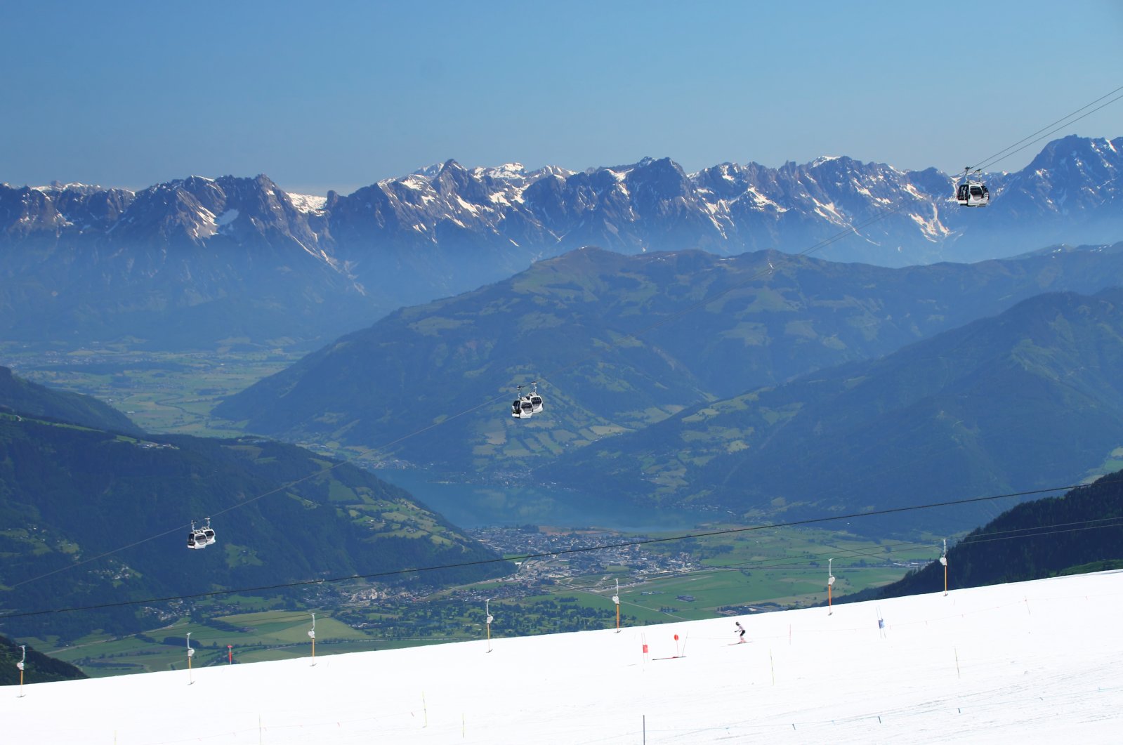 Kontraszt: síelő suhan a csillogó gleccserpályán, lent a völgyben strandolók keresnek felüdülést a Zelli tóban