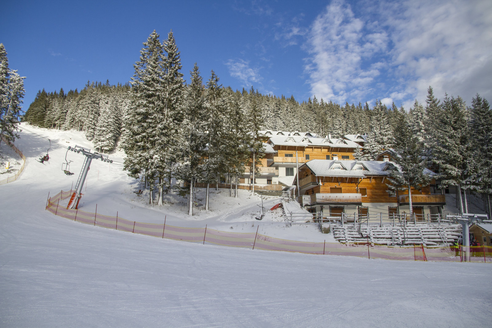 Az új apartmanok a Hotel Golte mögötti fenyőerdőben, a sípályák közvetlen közelében találhatók